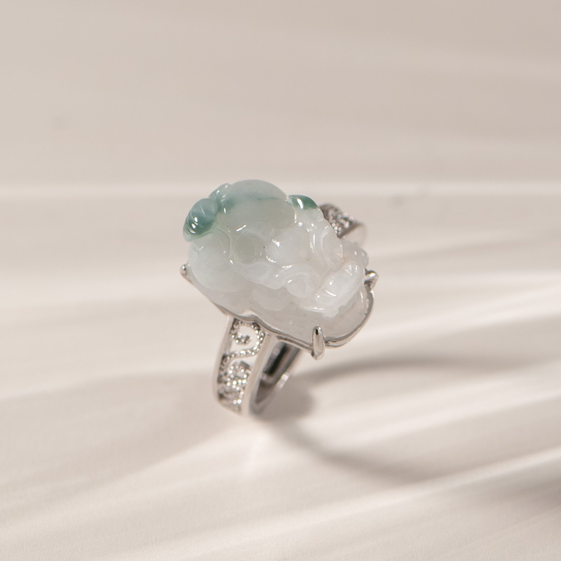 Jade ring with silver band on a light background