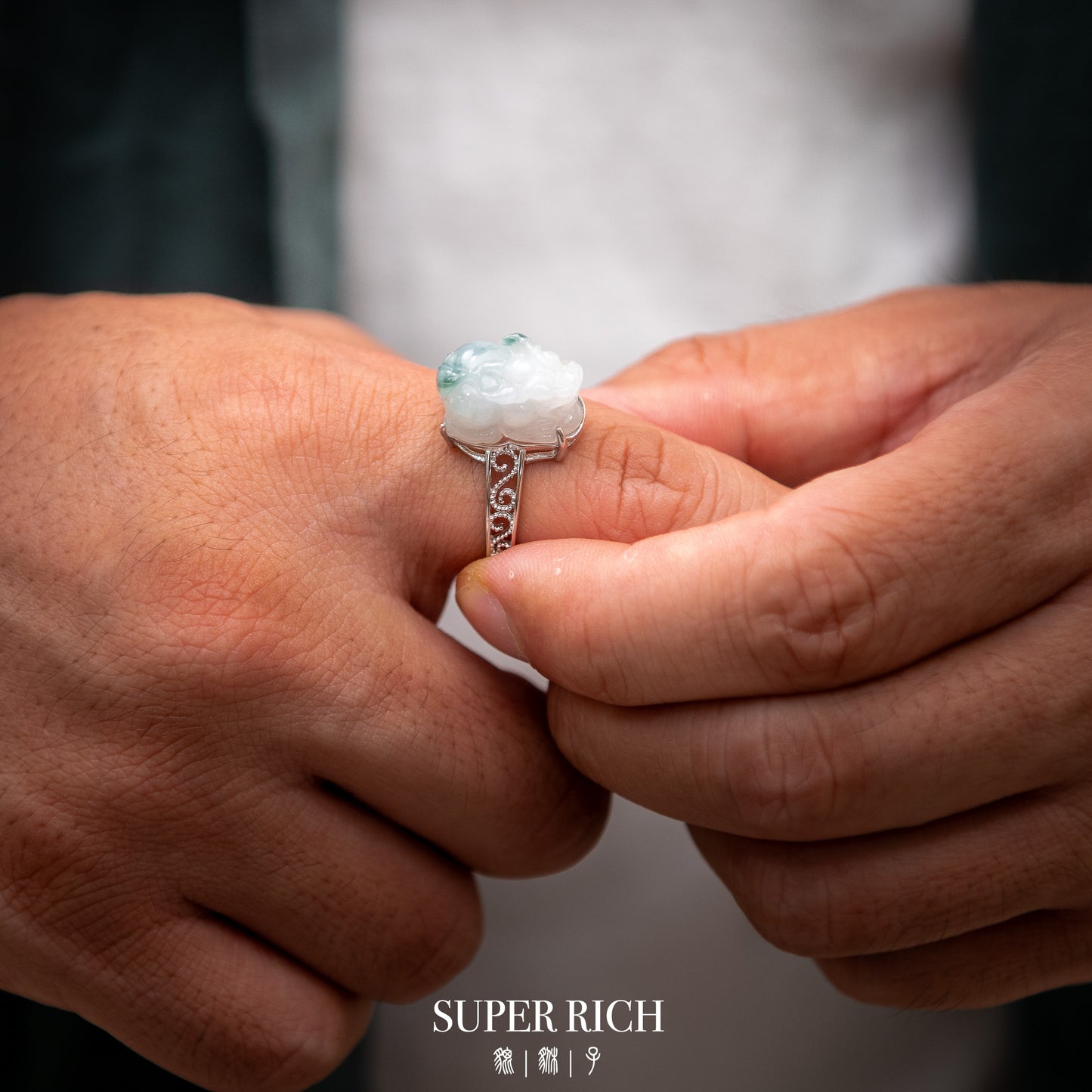 Close-up of hands holding a ring with a visible brand name.