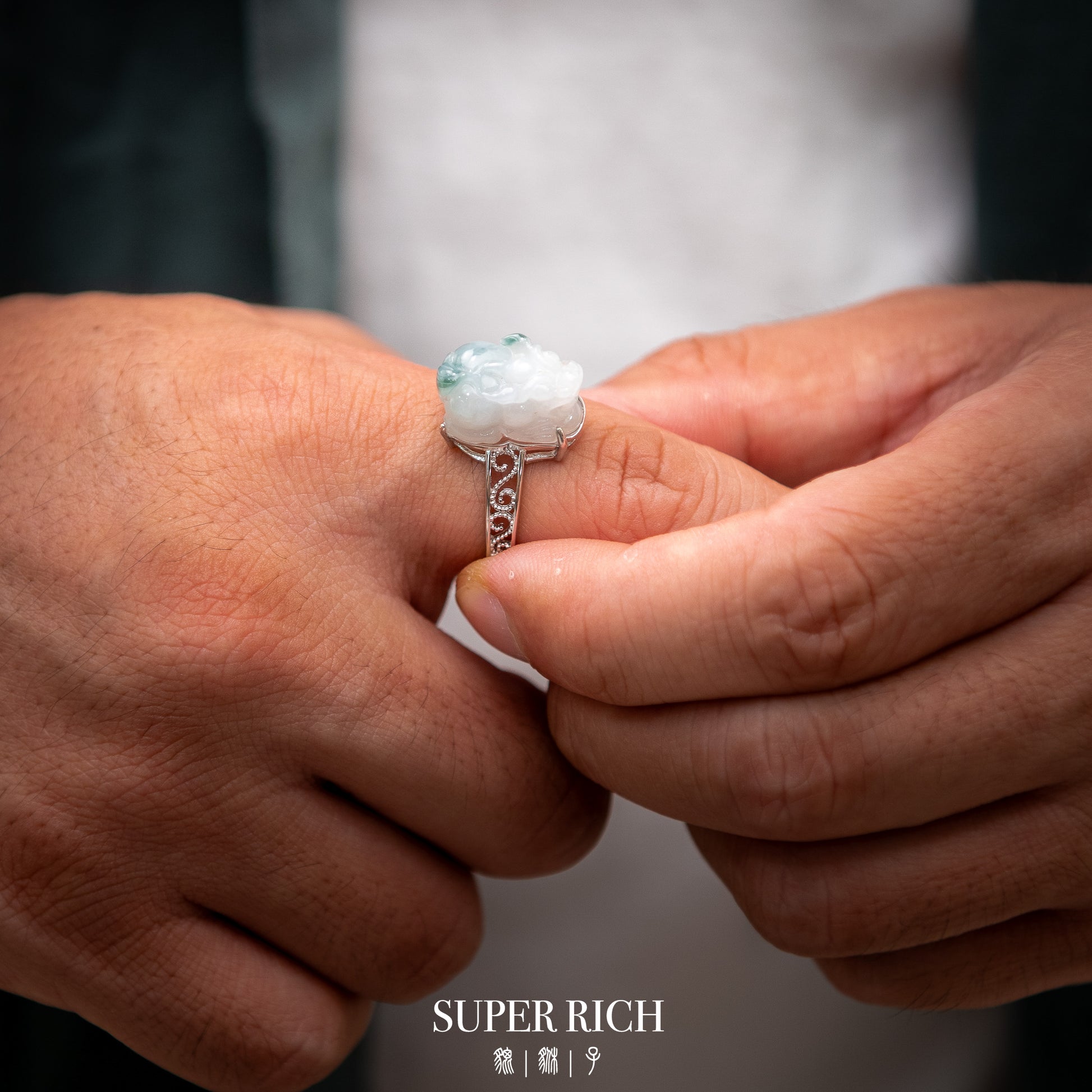 Close-up of hands holding a ring with a visible brand name.