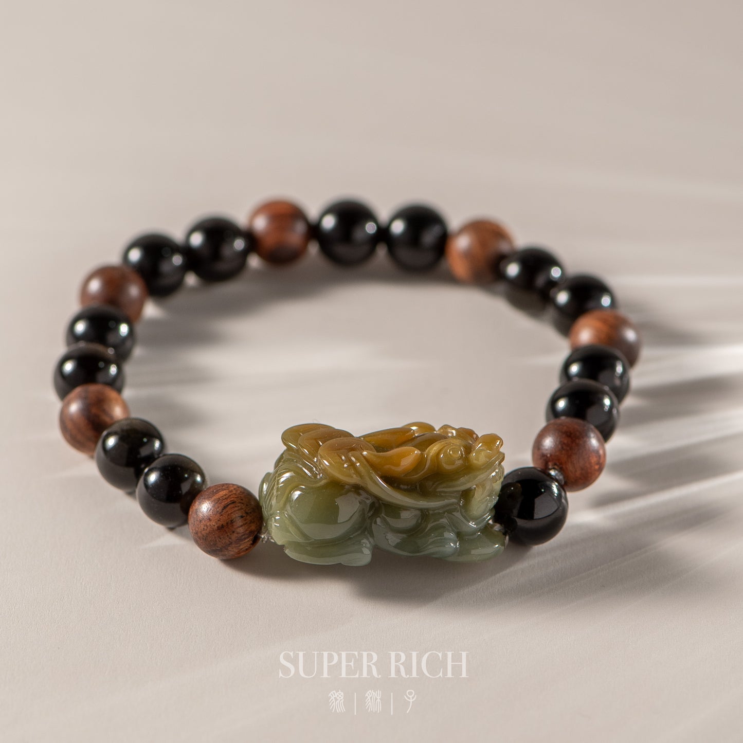 Beaded bracelet with a jade charm on a beige background, featuring the brand 'Super Rich'.
