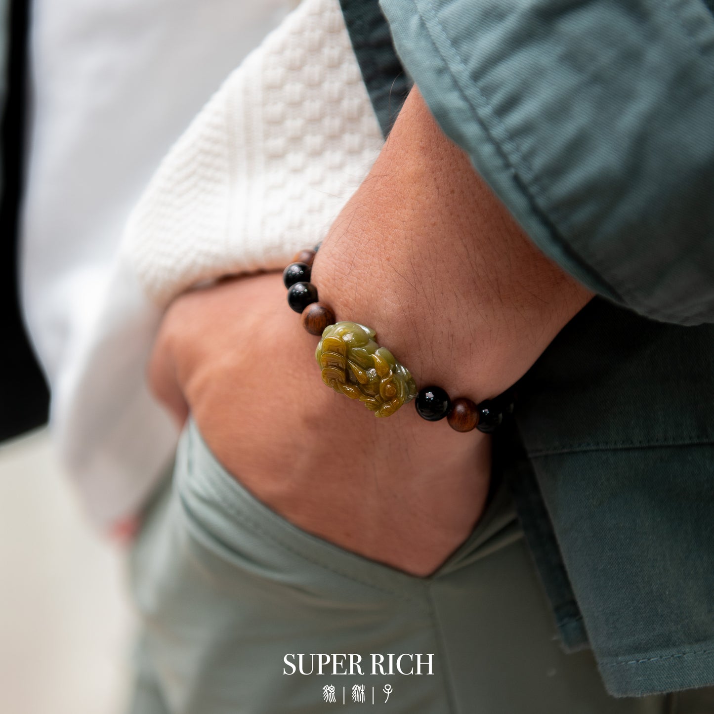 Close-up of a wrist wearing a beaded bracelet with a visible brand name.