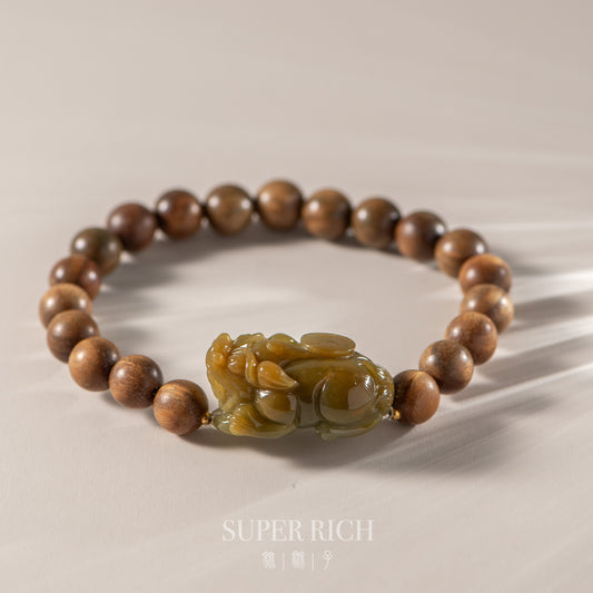Wooden beaded bracelet with a green stone charm on a beige background, featuring the brand 'Super Rich'.