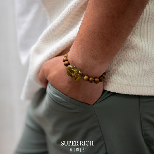 Person wearing a wooden beaded bracelet with a neutral background and 'SUPER RICH' branding.