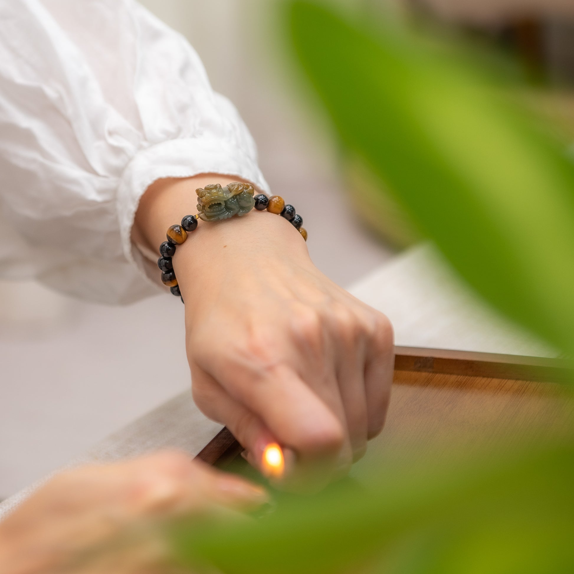 Person wearing a beaded bracelet with a blurred background