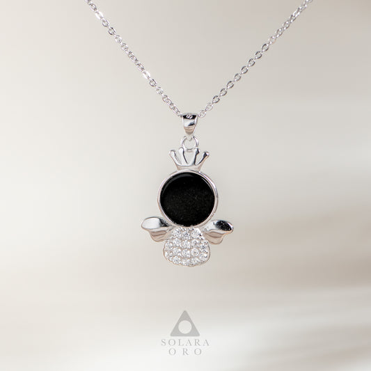 Silver pendant with black center and clear stones on a white background, featuring Solara Oro logo.