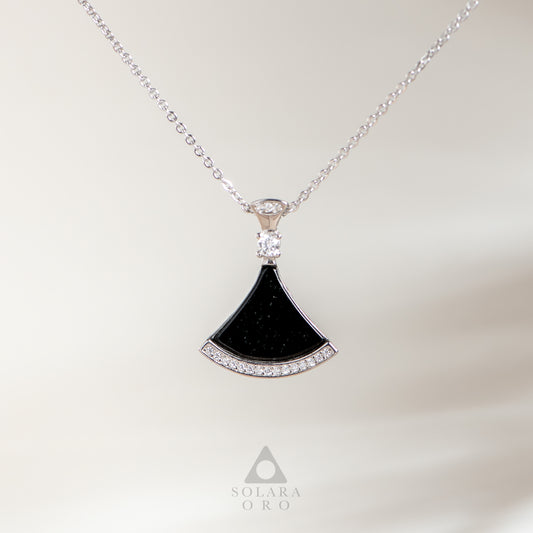 Black fan-shaped pendant with diamonds on a silver chain against a white background, featuring the Solara Oro logo.