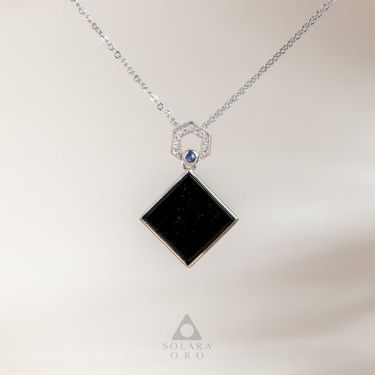 Necklace with a black square pendant and blue gemstone on a light background, featuring the brand 'Solara Oro'.