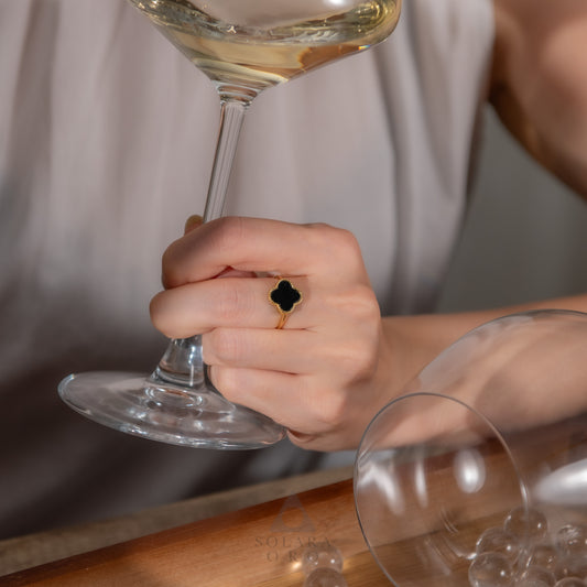 Hand holding a wine glass with a blurred background