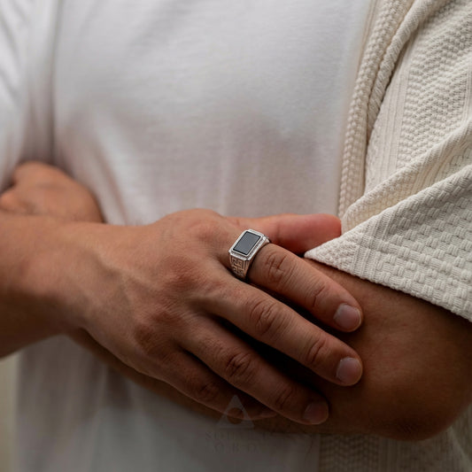 Hand wearing a ring with a white background