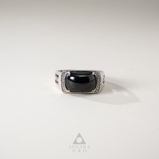 Silver ring with a black gemstone on a light gray background, featuring the Solara Oro logo.