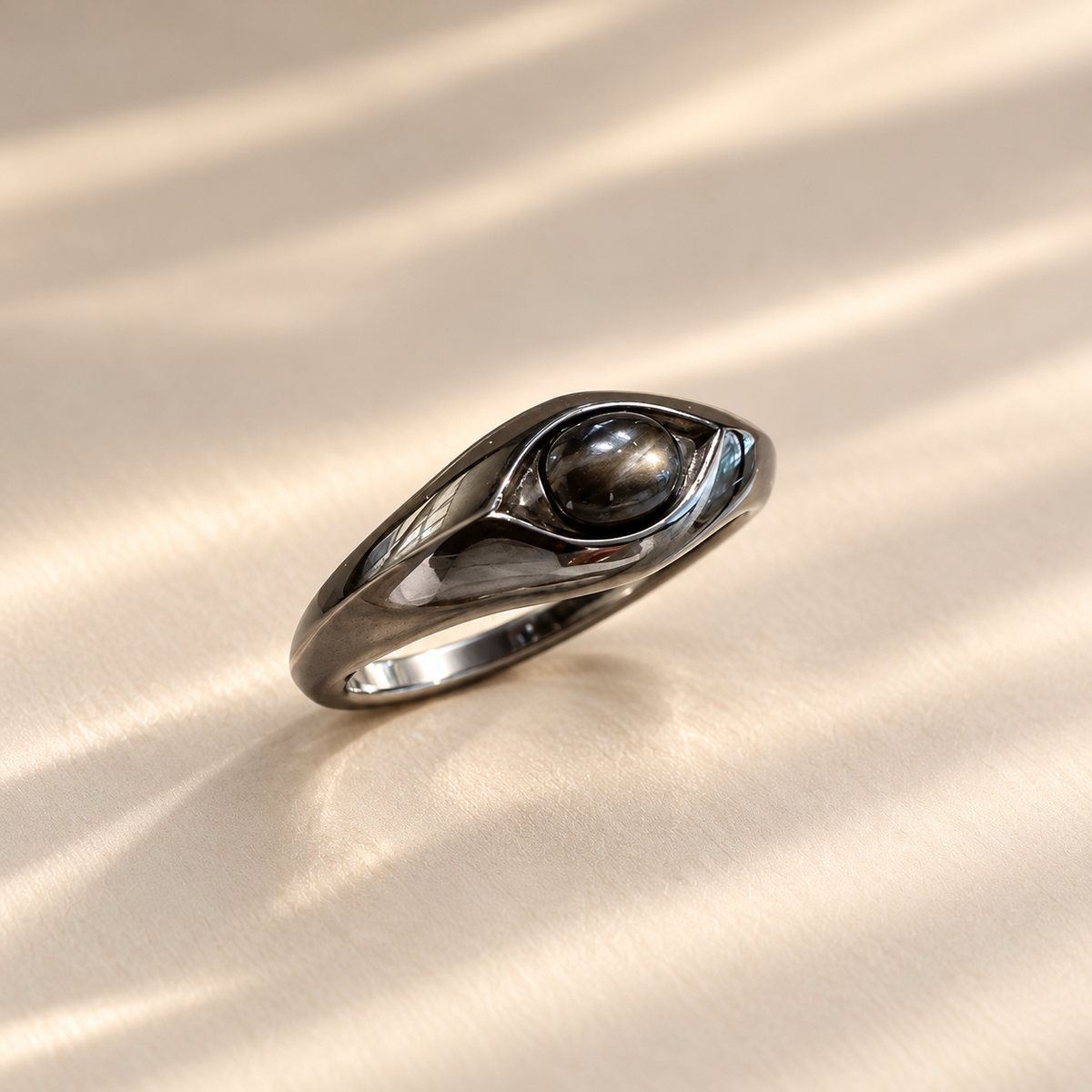 Black star sapphire oval cabochon ring in 925 sterling silver, angled view