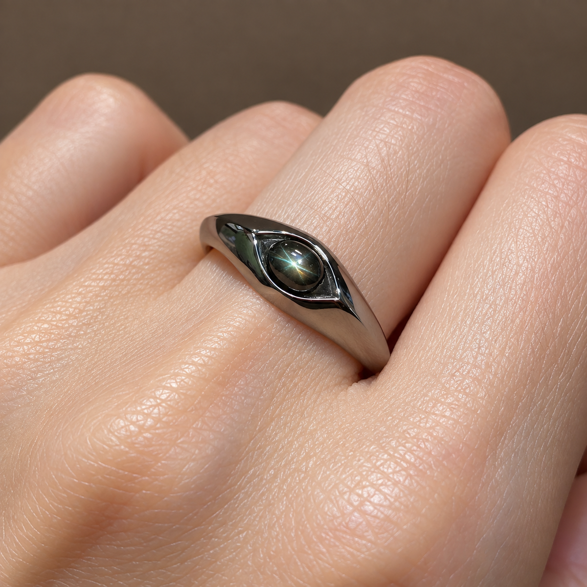 Close-up of black star sapphire oval cabochon set in 925 sterling silver ring