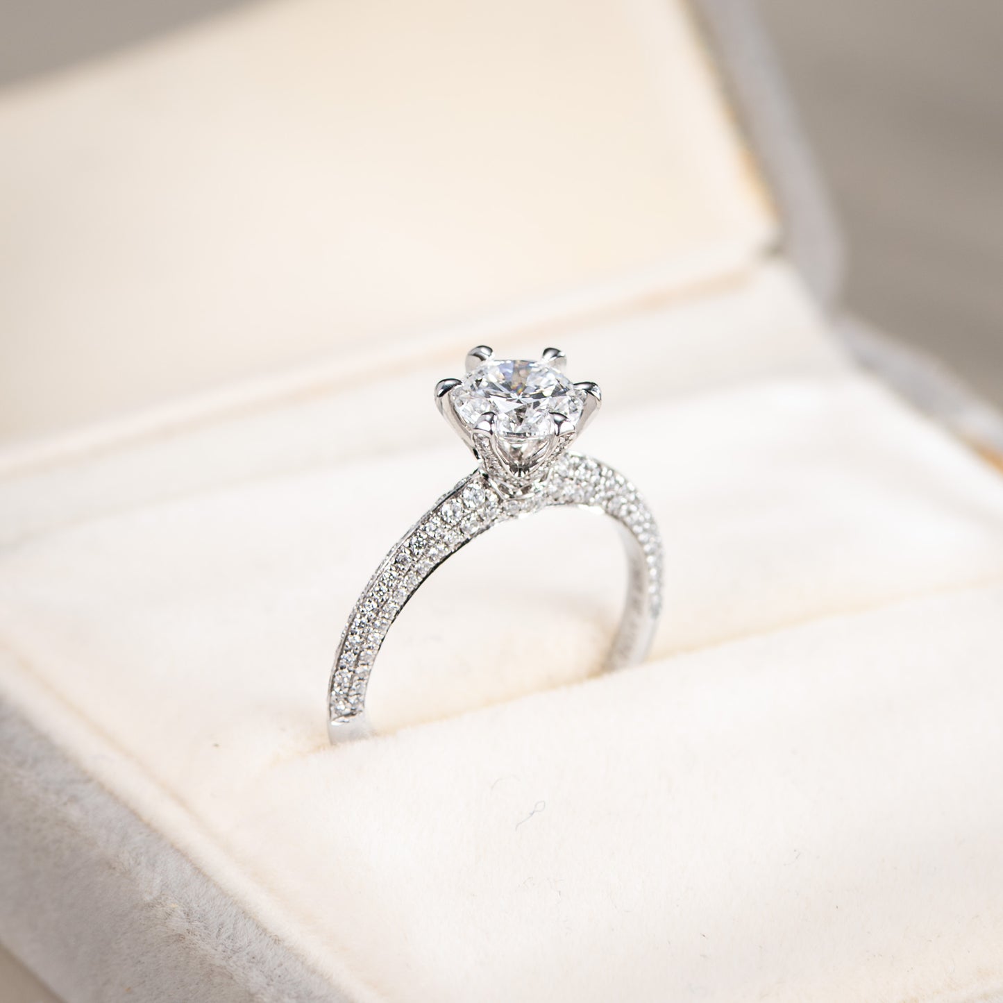 Silver ring with a diamond on a soft fabric background