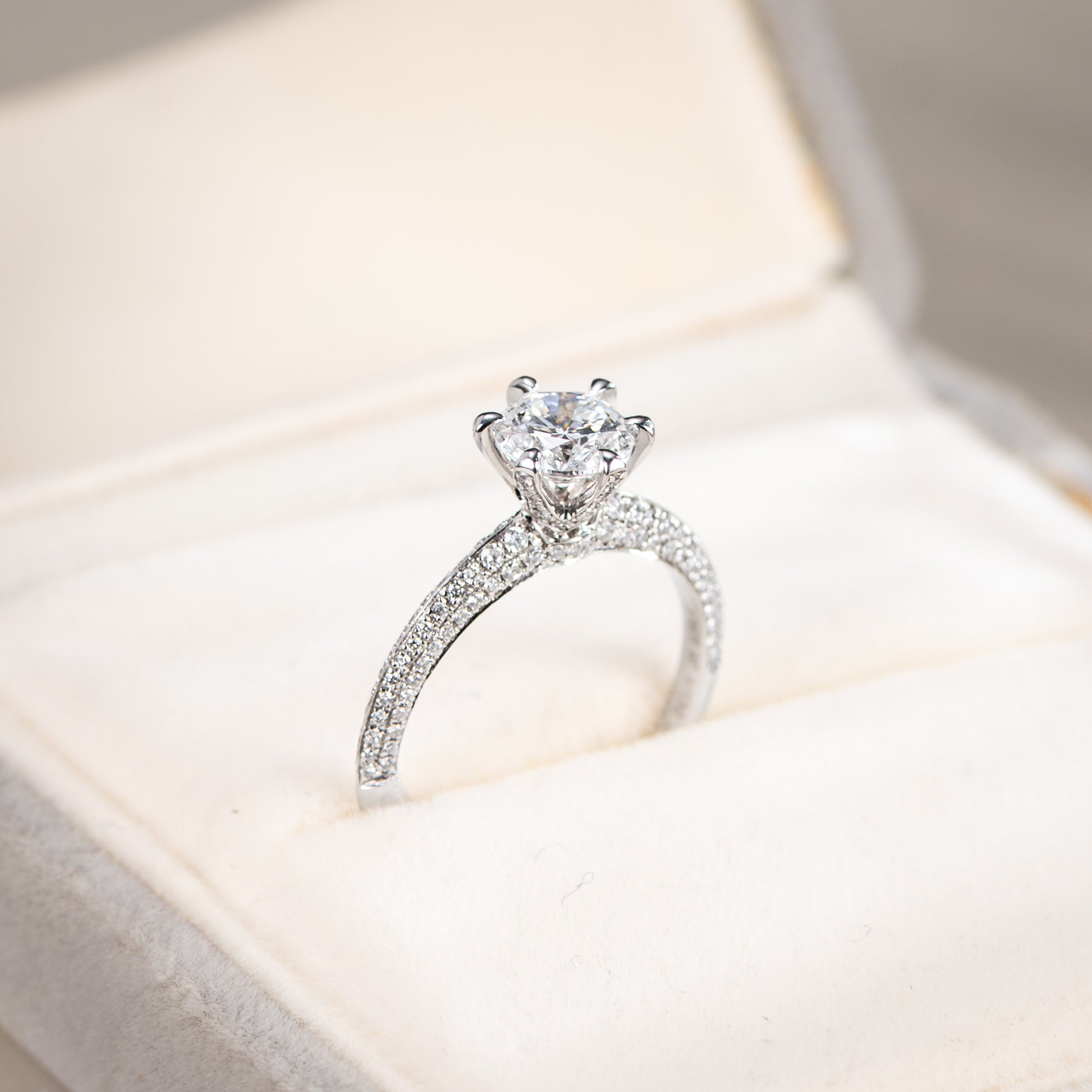 Silver ring with a diamond on a soft fabric background