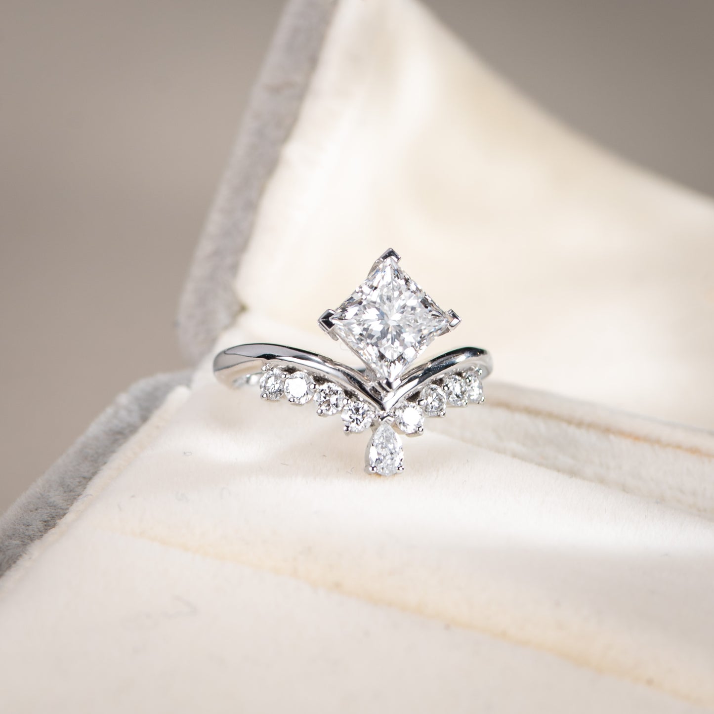 Silver ring with a diamond on a soft fabric background