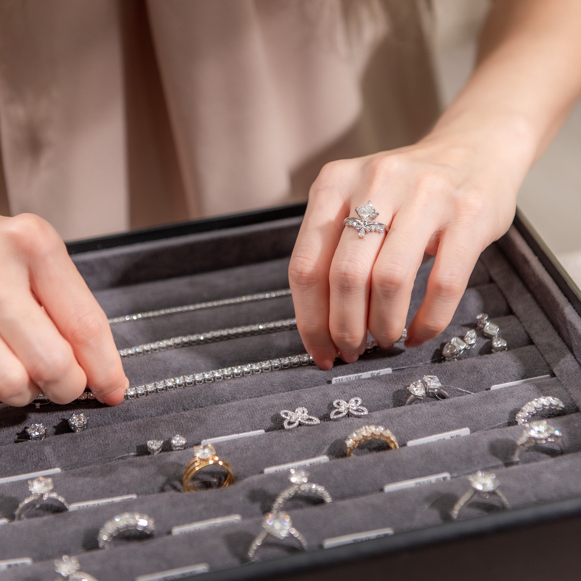 Person examining rings in a jewelry box