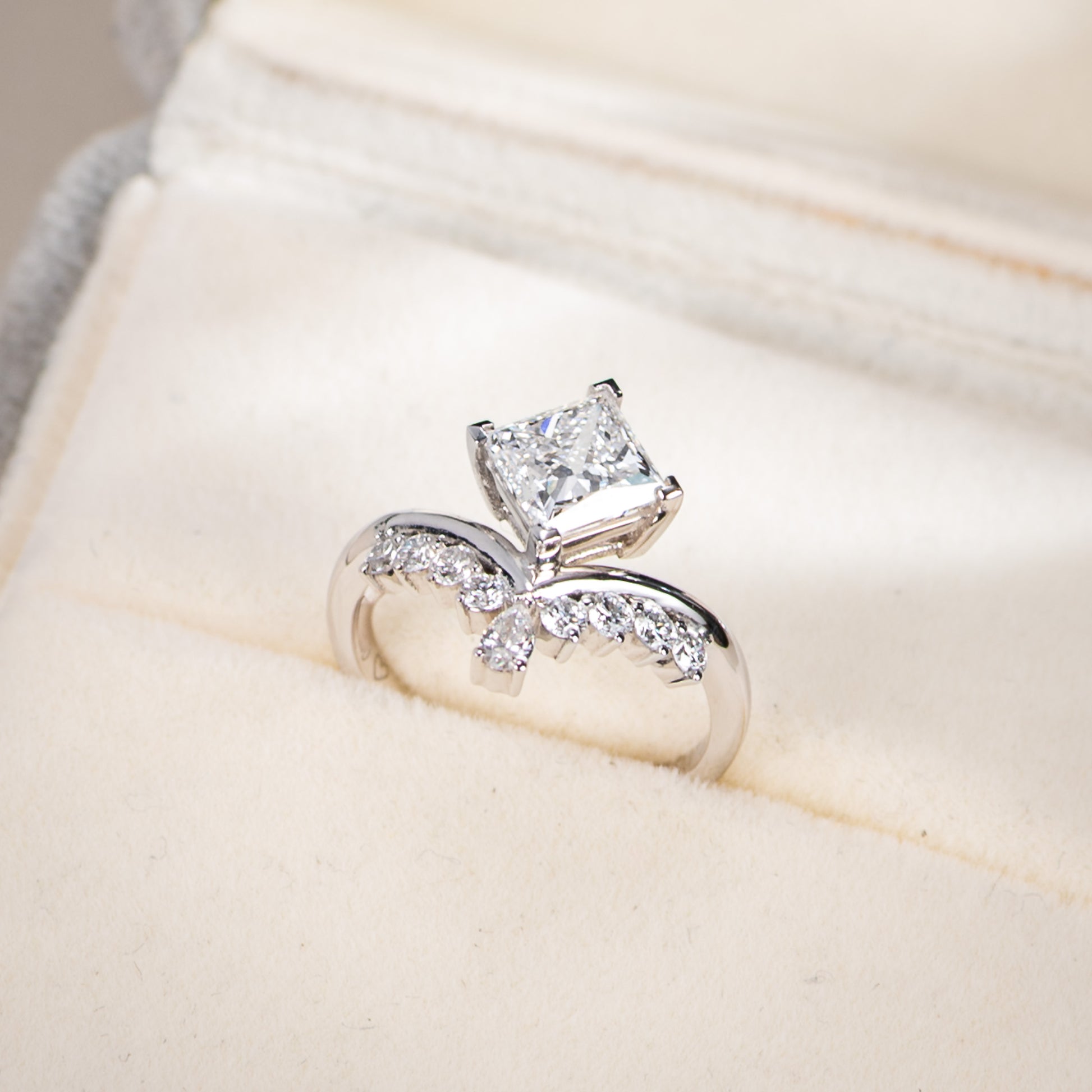 Diamond ring on a soft beige fabric background
