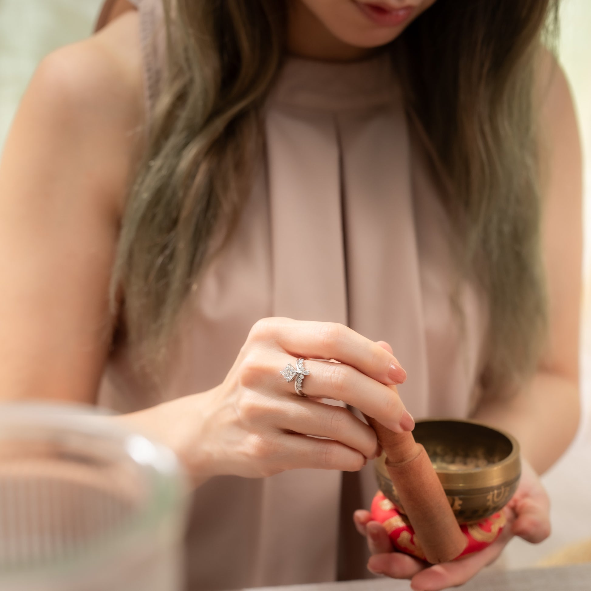 Person holding a small bowl with a blurred background