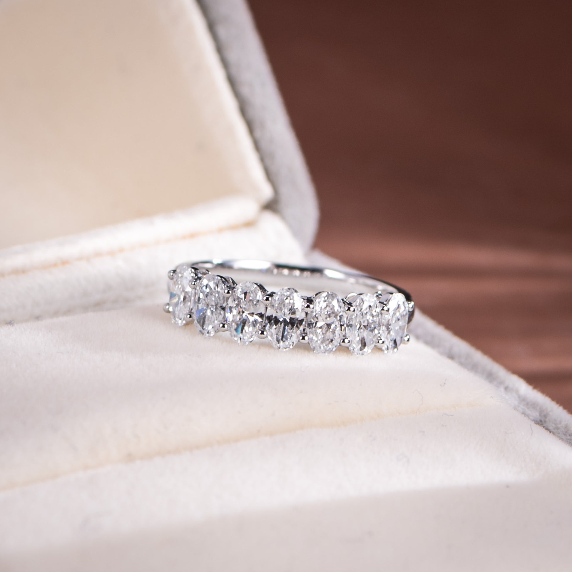Diamond ring on a soft, light-colored surface with a blurred background