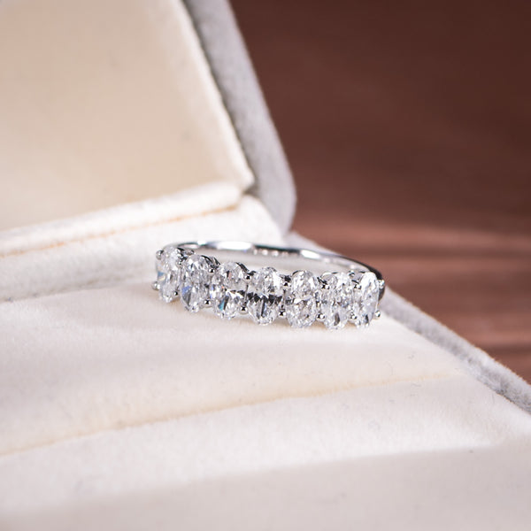 Diamond ring on a soft, light-colored surface with a blurred background