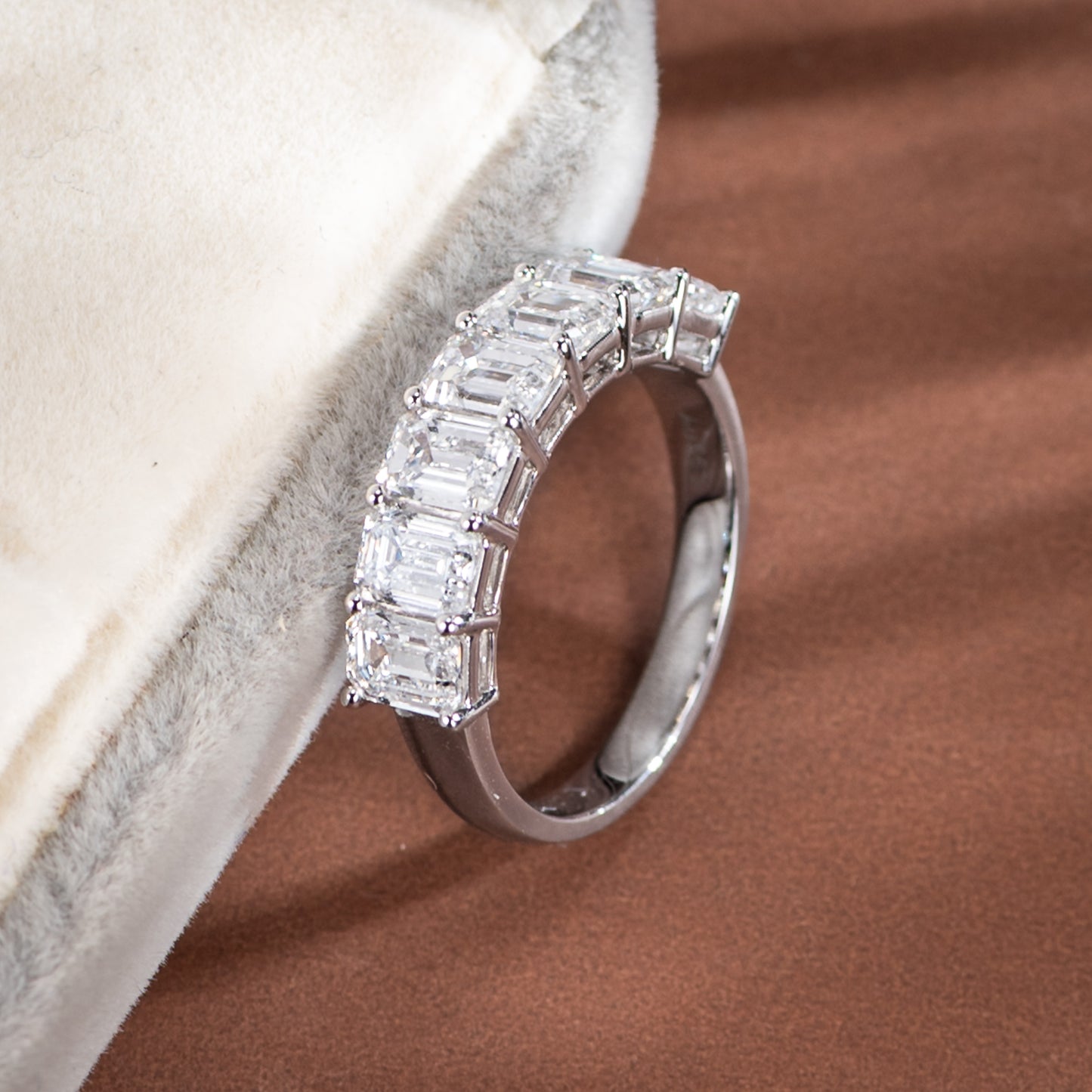 Silver ring with diamond accents on a textured surface