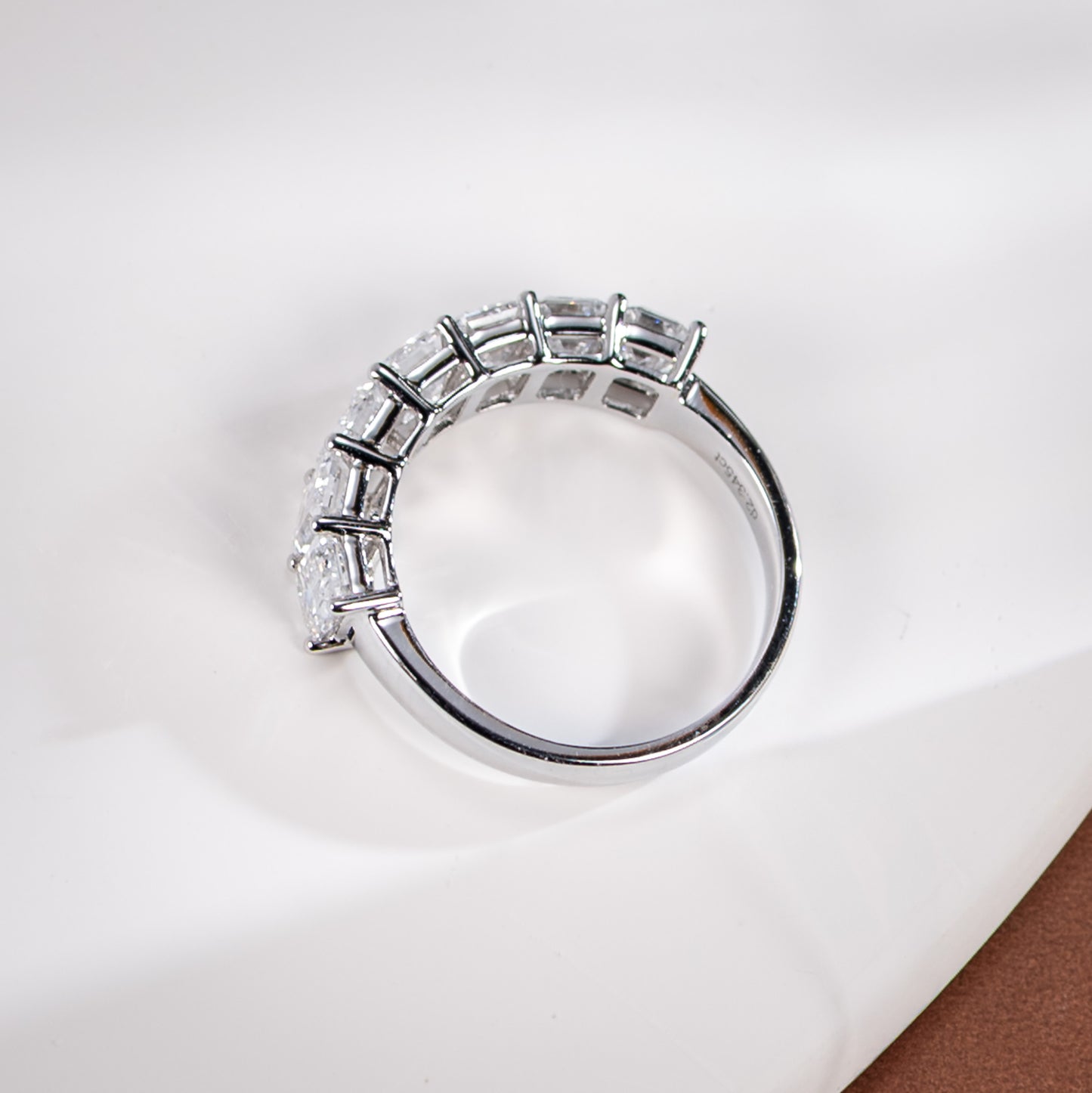 Silver ring with baguette-cut diamonds on a white background