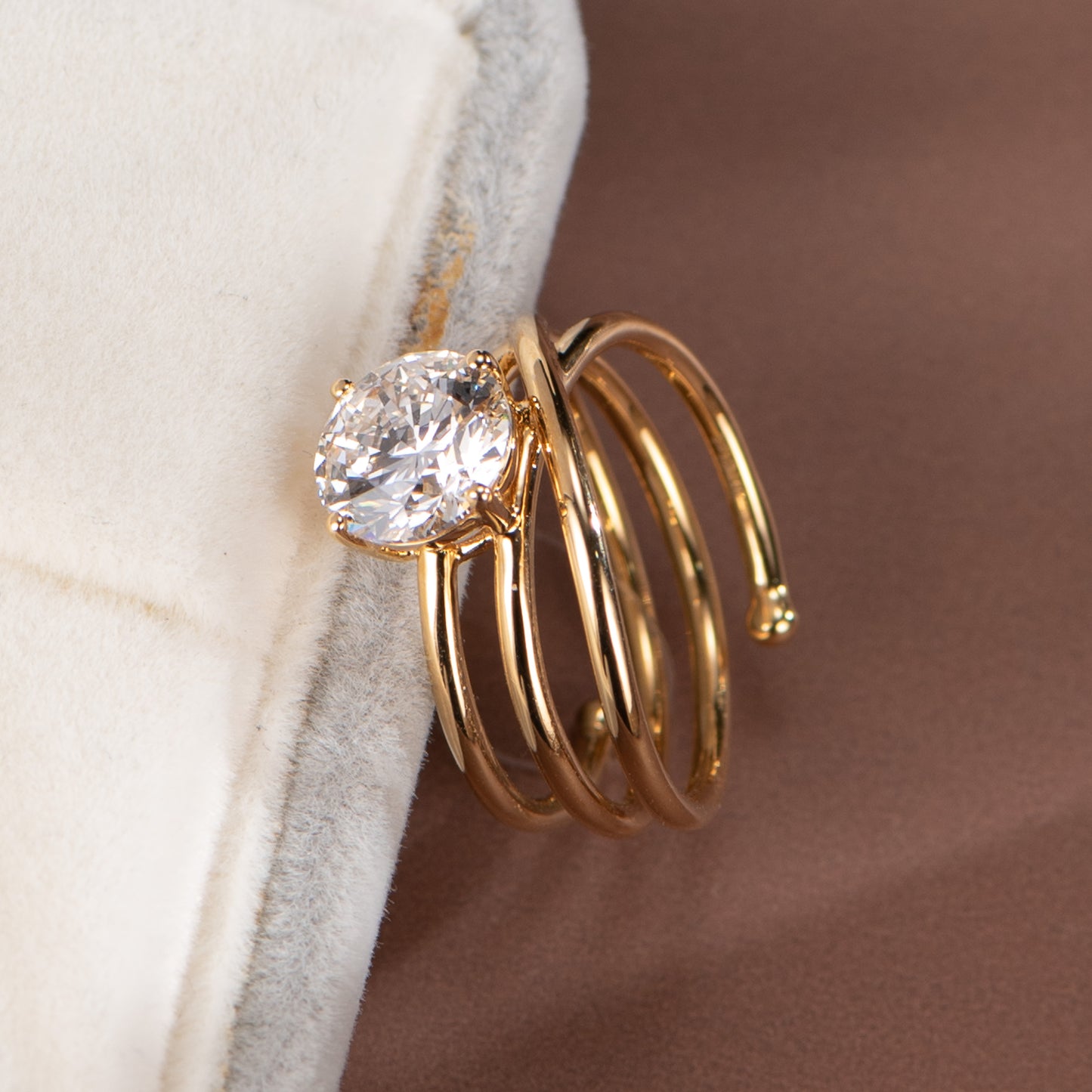 Gold ring with a diamond on a neutral background