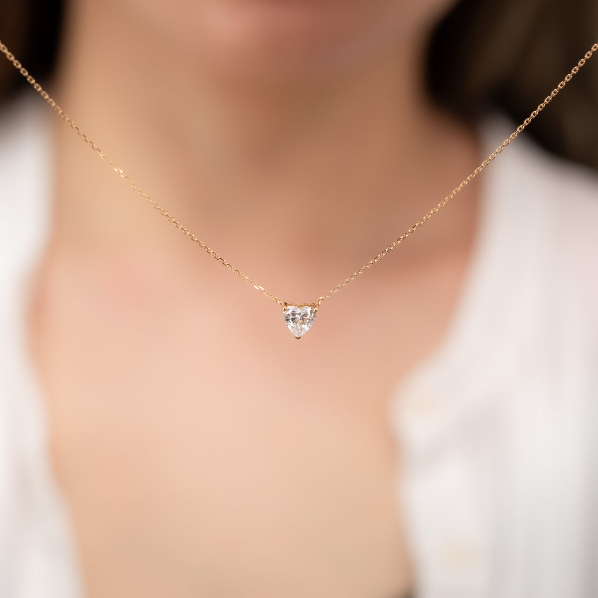 Aurora heart lab-grown diamond pendant worn at the collarbone