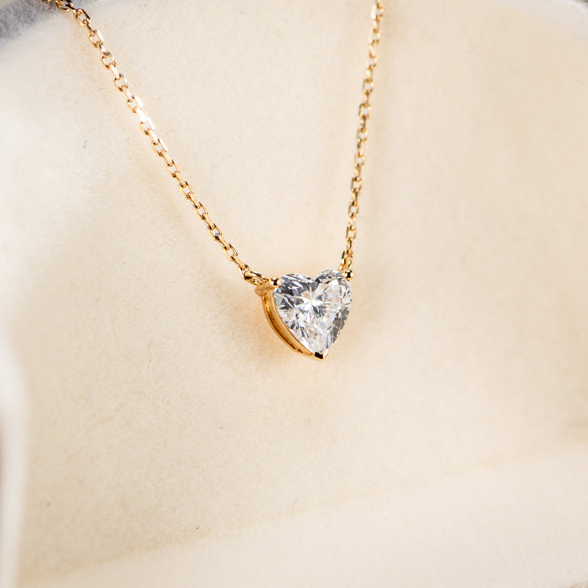 Aurora heart lab-grown diamond pendant, angled view showing the prong setting and gold chain